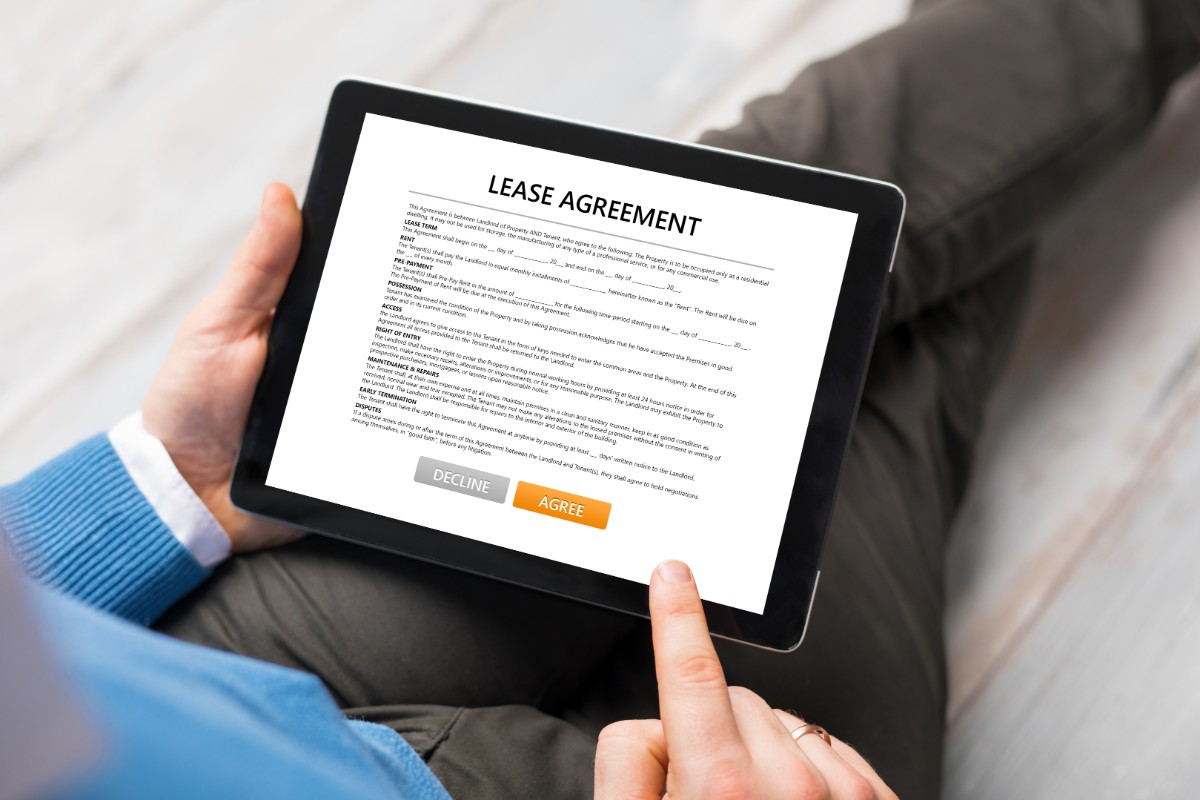 man reading lease agreement on a tablet